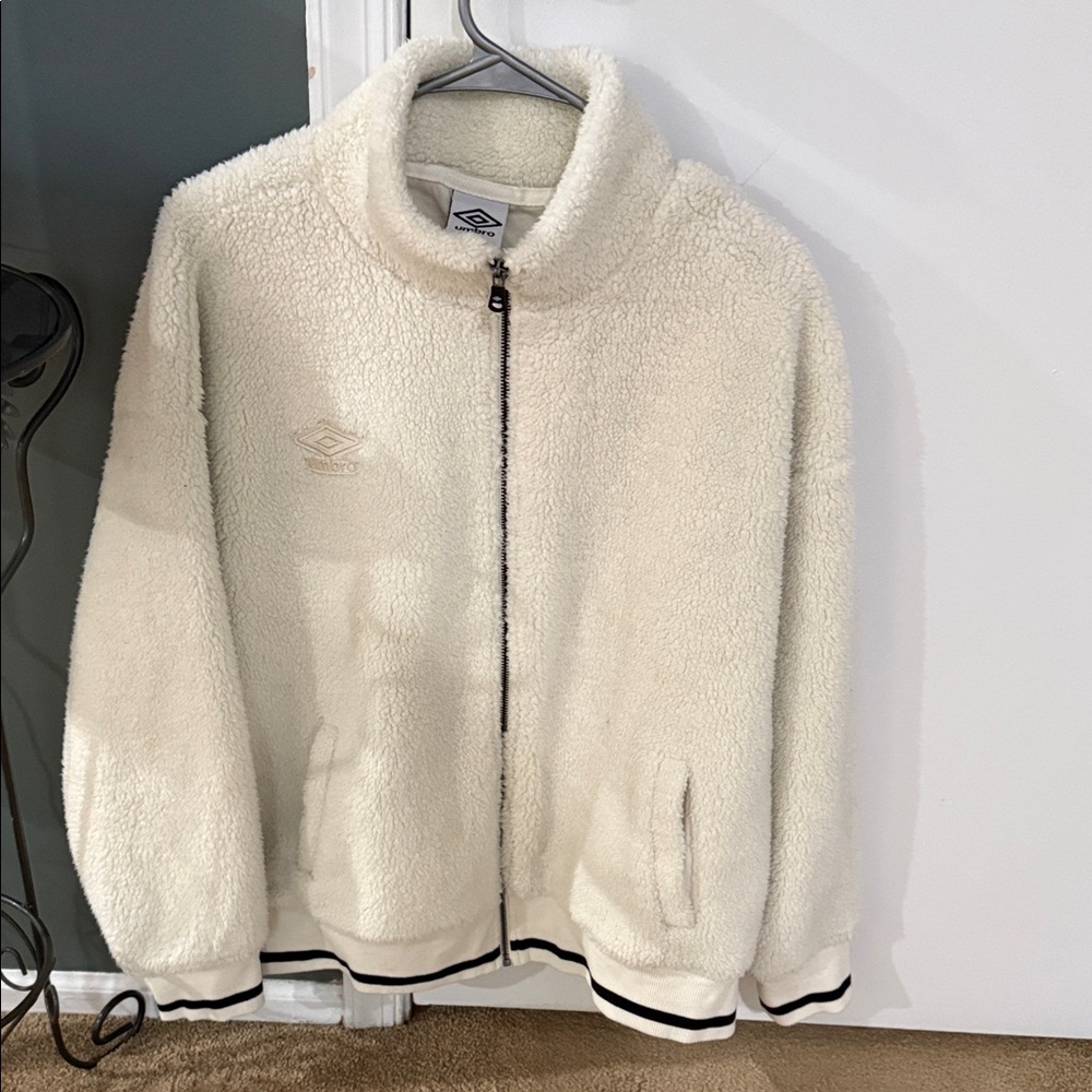 Umbro Cream Fleece Jacket with Black Accents . Has pockets
